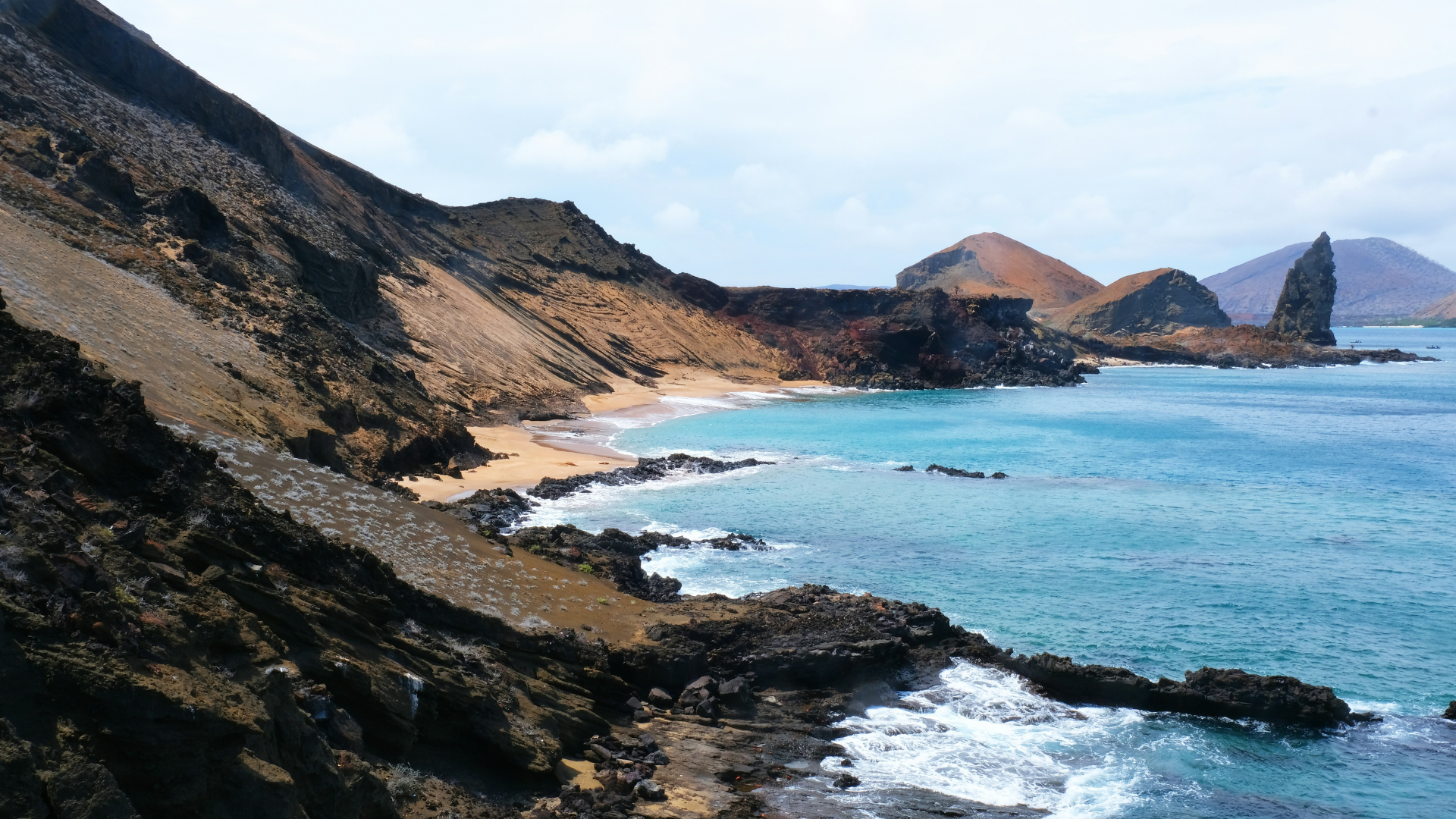 Beautiful view of the water and the pinnacle rock (right side) in the Galapagos.