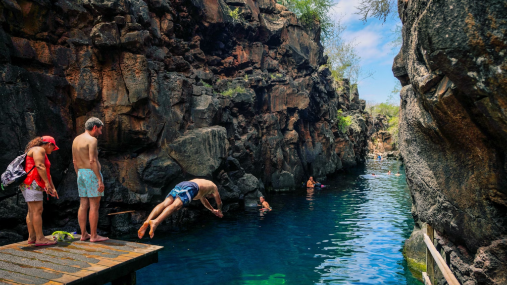 Tourists go for a dive in the blue waters of Las Grietas in the Santa Cruz Island of the Galapagos.