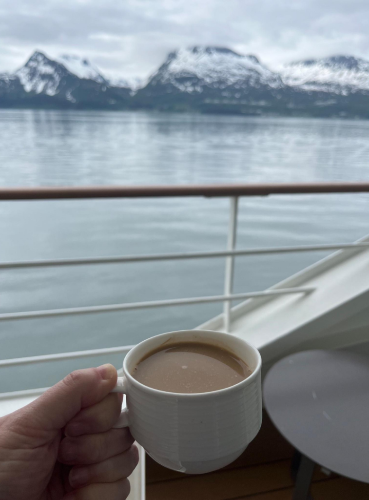 Coffee on the balcony on Silver Muse sailing in Alaska in June 2024.