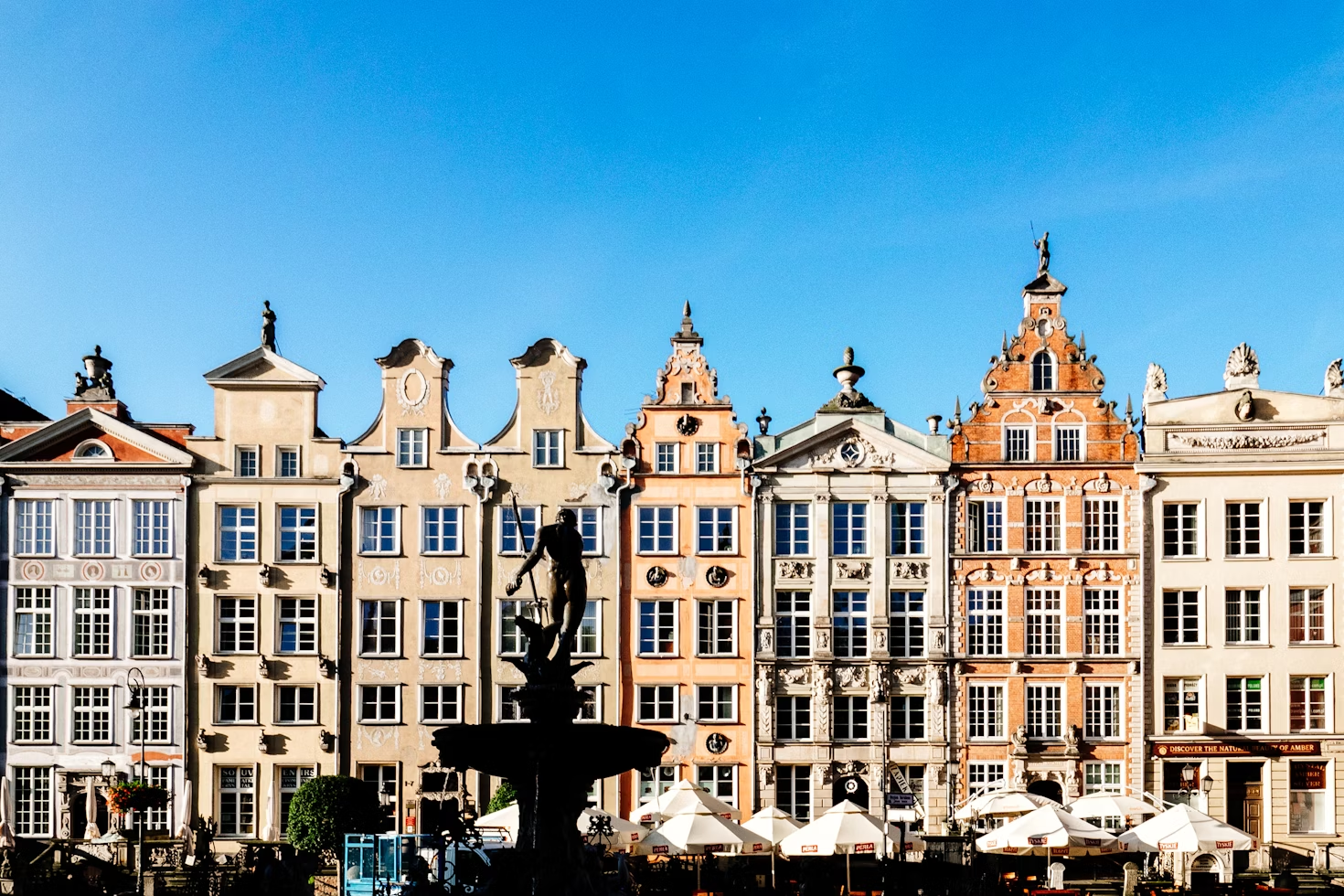 Row of buildings in Dlugi Targ near Old Town featuring the silhouette of  the Statue of Neptune in Gdansk. Photo courtesy of Andrea Anastasakis.