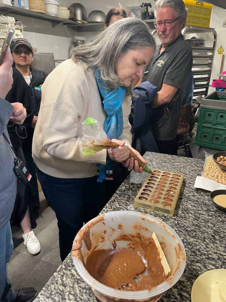 Michele making artisanal chocolates during a shore excursion in Ghent, Belgium, as part of an AmaWaterways cruise.