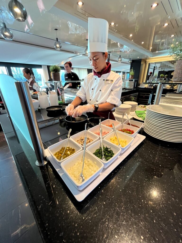 Chef preparing a gourmet meal onboard AmaWaterways, highlighting the attention to detail in luxury dining.